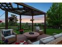Relaxing outdoor patio with fire pit and comfortable seating, perfect for enjoying evenings in a serene setting at 12119 S Wanderlust Way, Parker, CO 80138