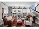 Bright living room showcasing built-in shelving, a decorative fireplace, and comfortable seating arrangements at 12119 S Wanderlust Way, Parker, CO 80138