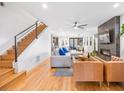 Open living area with hardwood floors, fireplace, and stairs to upper level at 3928 Vrain St, Denver, CO 80212