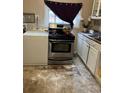 Kitchen with stainless steel oven and overhead microwave at 615 E 49Th Ave, Denver, CO 80216