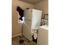 Laundry area with a white refrigerator and white washer at 615 E 49Th Ave, Denver, CO 80216