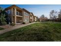 Well-maintained condo complex with lush green spaces, sidewalks, and inviting common areas at 2215 Calais Dr # G, Longmont, CO 80504