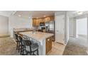 Bright kitchen featuring wooden cabinets, stainless steel appliances, and a convenient breakfast bar with seating at 2215 Calais Dr # G, Longmont, CO 80504