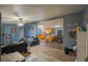 Open concept living room flows into the kitchen featuring sleek countertops and modern appliances at 15682 Morris Ave, Fort Lupton, CO 80621