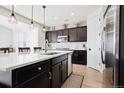 Open concept kitchen with white countertops, stainless steel appliances, and hardwood floors at 771 Dutton Ct, Castle Rock, CO 80104