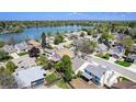 Scenic aerial view of a residential community, showcasing homes near a beautiful lake and lush greenery at 8281 Johnson St, Arvada, CO 80005