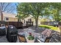 Serene backyard featuring a stone patio, grill, and a lush lawn, ideal for relaxation and outdoor activities at 8281 Johnson St, Arvada, CO 80005