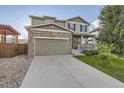 Two-story home with neutral siding, stone accents, attached two-car garage, and a charming front porch at 4827 S Coors Ln, Morrison, CO 80465