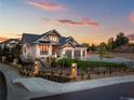 Stunning two-story home with a three-car garage and landscaped front yard at 6551 S Harlan Ct, Littleton, CO 80123