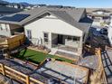 Backyard featuring an artificial grass patch, stone patio, and fencing at 17412 W 93Rd Pl, Arvada, CO 80007