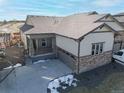 Charming home with a covered front porch, stone accents, three car garage and well-kept landscaping at 17412 W 93Rd Pl, Arvada, CO 80007