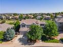 Beautiful gray two-story home featuring mature trees, a turret and an attached two car garage at 2980 Craig Ct, Castle Rock, CO 80109