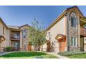 Exterior view of townhome featuring well-maintained landscaping and neutral-colored siding with stone accents at 3252 E 103Rd Dr # 708, Denver, CO 80229