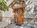 Welcoming front door featuring decorative wreath, sidelight window, and covered entryway at 3252 E 103Rd Dr # 708, Denver, CO 80229