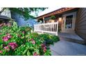 Landscaped front yard featuring vibrant flowers, manicured greenery, and a charming walkway leading to the front door at 5150 Morning Glory Pl, Highlands Ranch, CO 80130