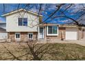 Charming two-story home featuring a brick and siding exterior, attached garage and a well-maintained front yard at 18835 E Utah Cir, Aurora, CO 80017