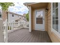 Inviting front porch featuring a white picket fence and a stylish exterior door with glass, enhancing curb appeal at 8463 Everett Way # B, Arvada, CO 80005