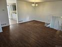 Open dining area with laminate flooring, a chandelier, and stairwell access at 4582 Frankfort Way, Denver, CO 80239