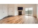 Bright living room featuring wood floors, a fireplace, sliding glass doors and plenty of natural light at 3872 S Dallas St # 7-304, Aurora, CO 80014