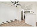 Open concept living room and kitchen area with laminate flooring at 1113 W 112Th Ave # B, Denver, CO 80234