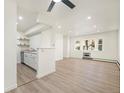 Open living room and kitchen with laminate wood floors at 1113 W 112Th Ave # B, Denver, CO 80234