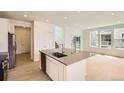 Bright, modern kitchen with stainless steel appliances, island, and light wood floors at 6740 Juniper Dr, Thornton, CO 80602