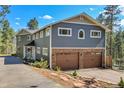 Charming home with stone accents, a two-car garage, and a well-maintained front yard at 4574 Picutis Rd, Indian Hills, CO 80454