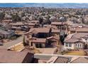 Gorgeous aerial view of the neighborhood showcasing beautiful homes and distant mountain views at 9355 E Winding Hill Ave, Lone Tree, CO 80124