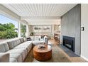 Inviting living room with a cozy fireplace and views through expansive windows at 1440 S Clermont St, Denver, CO 80222