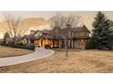 Charming exterior elevation showcasing the beautiful landscaping, large windows, and well-maintained lawn at 4041 E Forbes Ct, Greenwood Village, CO 80121