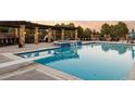 Refreshing swimming pool area with a diving board, waterfall feature, and comfortable poolside seating under a pergola at 4041 E Forbes Ct, Greenwood Village, CO 80121