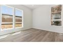 Bright bedroom with wood floors and large windows at 11475 E Briarwood Cir, Centennial, CO 80112