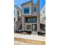 Modern three-story home featuring a brick facade and a second-story balcony at 11475 E Briarwood Cir, Centennial, CO 80112