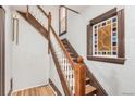 Classic staircase with decorative wood trim, elegant balusters, and a unique stained glass window at 2227 N Gilpin St, Denver, CO 80205