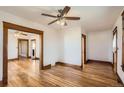 Spacious living room with hardwood floors, open layout, and classic trim throughout at 101 2Nd St, Fort Lupton, CO 80621