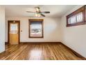 Bright living room featuring hardwood floors, trim details, ceiling fan, and natural light at 101 2Nd St, Fort Lupton, CO 80621