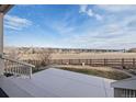 Spacious backyard with a large patio and scenic views of the open landscape beyond the fence at 7408 Xenophon St, Arvada, CO 80005