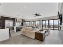 Open concept living room with stone floors and lots of natural light at 3520 Castle Butte Dr, Castle Rock, CO 80109
