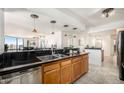 Open kitchen featuring dark countertops, light-wood cabinetry, and seating area at 1625 Larimer St # 2601, Denver, CO 80202