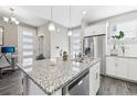 Modern kitchen with white cabinets, granite island, and stainless steel appliances at 21795 E 8Th Ave, Aurora, CO 80018