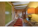 Inviting entryway featuring stone flooring, wood paneled walls, and a decorative green door at 638 Kinnikinnik Hl, Golden, CO 80401