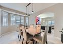 Elegant dining room with stylish lighting, large windows, and an open view at 5470 S Jasper Way, Centennial, CO 80015