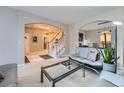 Inviting foyer with staircase, open floor plan, and views of the living area at 5470 S Jasper Way, Centennial, CO 80015