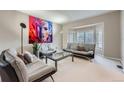 Bright and airy living room featuring modern furniture, large windows and neutral decor at 5470 S Jasper Way, Centennial, CO 80015
