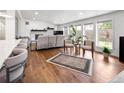 Inviting living room filled with natural light, a fireplace, hardwood floors, and modern furniture at 2175 S Joliet St, Aurora, CO 80014