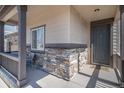 Inviting covered front porch with stone accents and neutral siding enhances the exterior appeal at 2243 Villageview Ln, Castle Rock, CO 80104