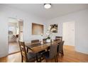 Elegant dining room with hardwood floors, a modern light fixture, and room for six at 1901 S Lincoln St, Denver, CO 80210