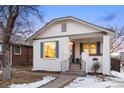 Charming white brick home with blue shutters, updated landscaping, and inviting front porch at 1901 S Lincoln St, Denver, CO 80210