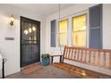 Inviting front porch with swing bench and secure door at 1901 S Lincoln St, Denver, CO 80210