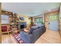 Inviting living room with wood paneling, a stone fireplace, and comfortable seating at 2844 Bellaire St, Denver, CO 80207